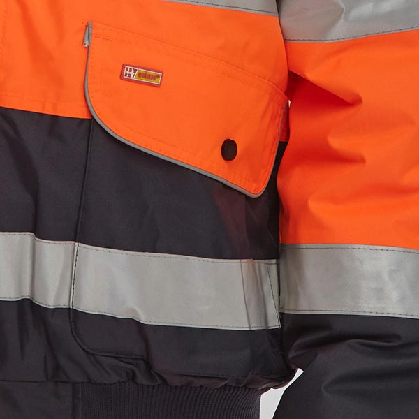 close up of pocket detail on orange and navy hi vis jacket