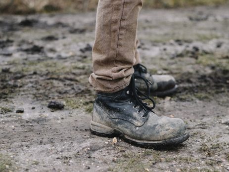 workman wearing boots in muddy autumn winter